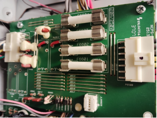 A green circuit board with many wires and wires